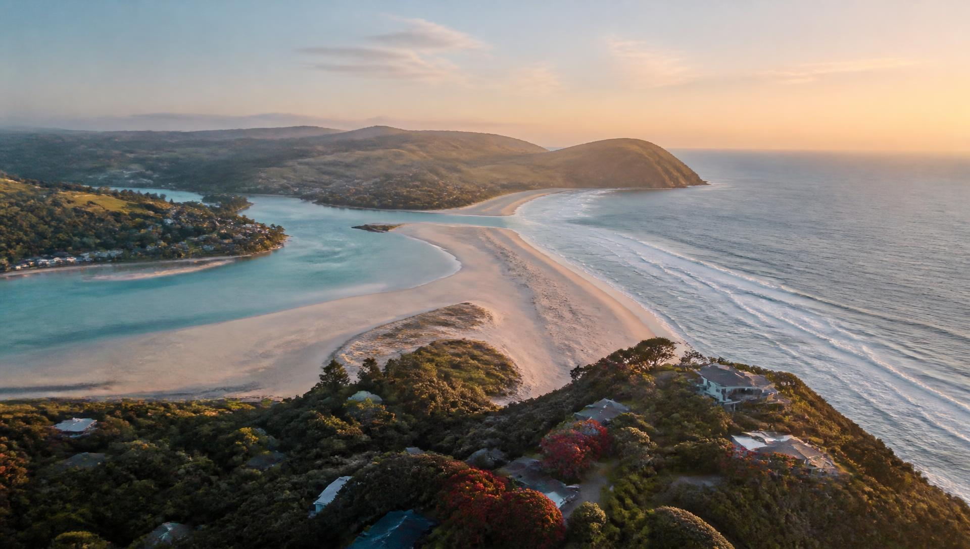 Aerial view of the Mangawhai Heads coastline and estuary at sunrise